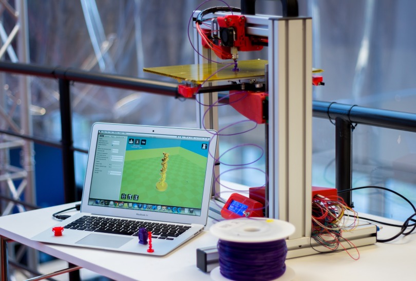 A typical 3D printing set-up. Includes a FELIX 3D Printer currently printing, a Macbook running 3D printing software and some example 3D printed objects.